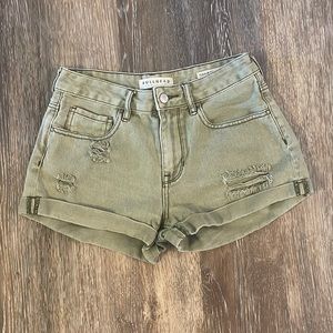 High-rise green denim shorts.
